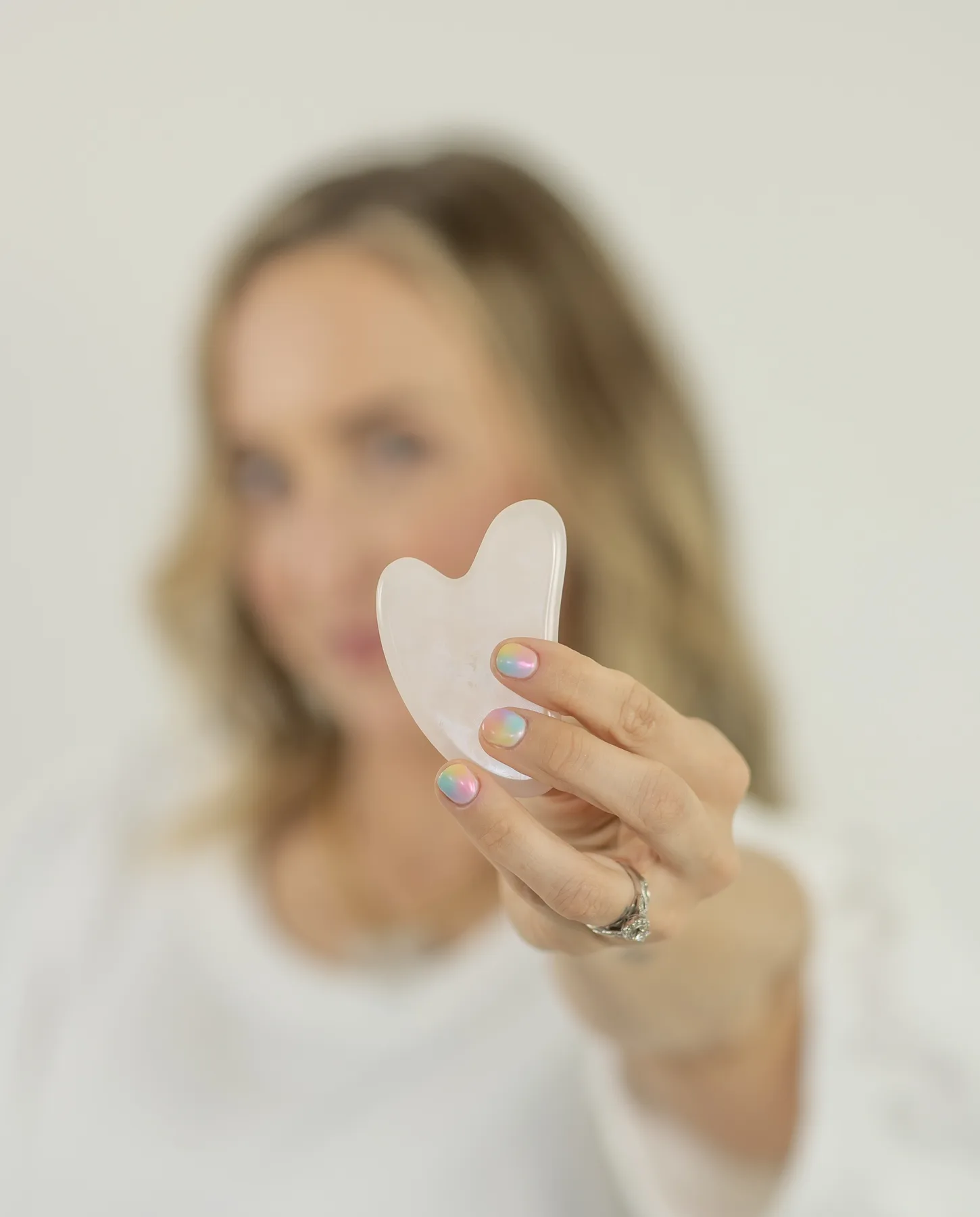 Gua sha facial tool used in Sacred Skin treatments